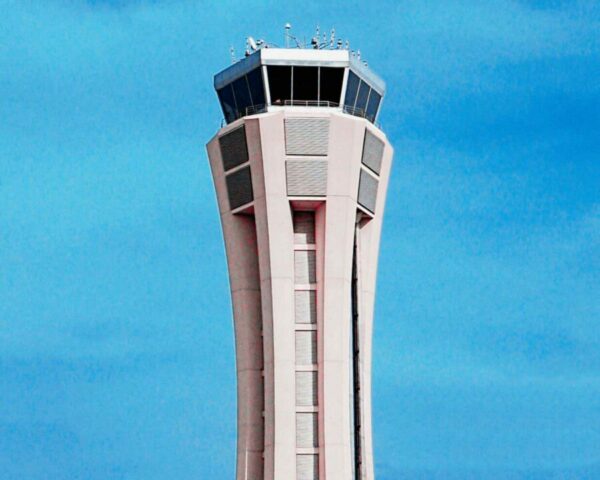 Close-up view of the control tower at Málaga Airport with a clear blue sky in the background